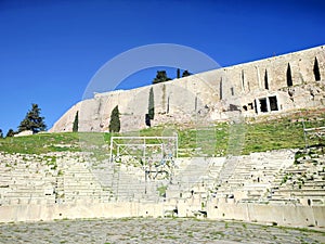 Photo of the ancient Theatre of Dionysus, and the Choregic Monument of Thrasyllos (Upper right corner) in Athens.