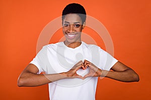 Photo of androgyne lady show hand heart gesture chest support unity wear stylish t-shirt isolated shine color background