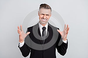 Photo of angry furious mature broker dressed black suit rising arms hands screaming isolated grey color background