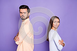 Photo of angry sad man and woman couple look each other stand back to back conflict folded hands isolated on purple