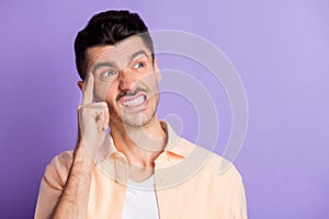 Photo of angry smart man finger temple look up empty space wear beige shirt isolated violet color background