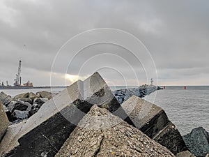 Photo of an artificial stone breakwater in the port at the sea gate