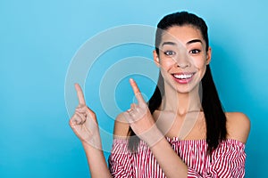 Photo of asian pretty girl model showing news direct finger empty copy space mockup adv ad ads isolated blue color