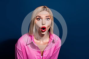 Photo of astonished gorgeous girl with bob hairdo dressed pink shirt staring at impressive discount isolated on dark