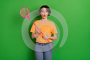 Photo of astonished shocked person arms hold butterfly net pouted lips isolated on green color background