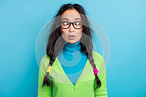 Photo of astonished speechless young schoolgirl wear glasses stand stupor isolated on bright blue color background photo