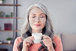 Photo of attractive aged woman happy positive smile enjoy morning hot coffee dream break pause indoors