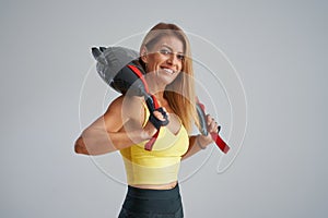 Photo of attractive blonde woman doing training with sandbag