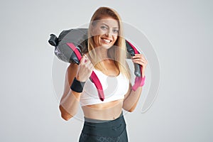 Photo of attractive blonde woman doing training with sandbag