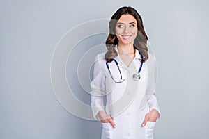 Photo of attractive family doc experienced lady consultant assistant virology clinic look side empty space beaming smile