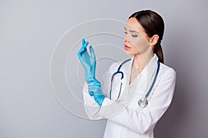 Photo of attractive family doc skilled experienced professional surgeon take on latex gloves prepare to operation wear