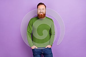 Photo of attractive foxy male holding hands in pockets posing on camera wear green pullover isolated on violet color