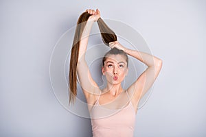 Photo of attractive funny lady demonstrate ideal groomed long healthy hairdo making amazing unbelievable tail look up