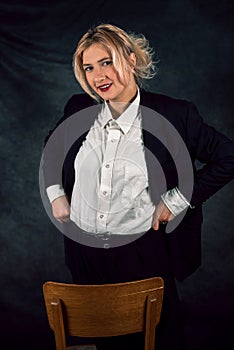 photo of attractive gorgeous business woman sitting on chair wearing suit isolated on plain background