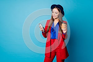 Photo of attractive lady hold telephone hands read corporate email message good news drink takeout coffee wear red