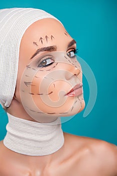 Photo of attractive lady in medical bandage have facial correction marks for plastic surgery over cyan background