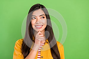 Photo of attractive minded creative young woman look empty space smart isolated on green color background