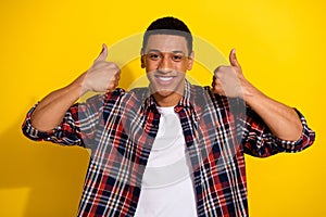 Photo of attractive nice man wear trendy plaid clothes showing quality thumb up isolated on yellow color background