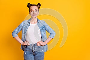 Photo of attractive pretty young teen lady two buns hairdo hold arms by sides student college university look interested