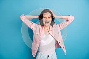 Photo of attractive shocked crazy lady hold arms on head open mouth listen amazing news good mood beaming smile wear