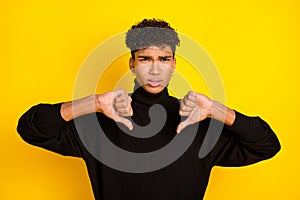 Photo of attractive upset dark skin man wear black sweater showing dislike signs isolated yellow color background