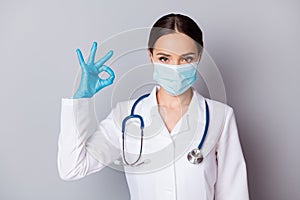 Photo of attractive virologist doc professional showing okey symbol hand fingers answer patient examination results wear