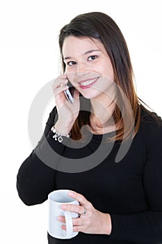 Photo of attractive woman 20s smiling and holding cup of coffee tea and speaking to mobile phone isolated over white background