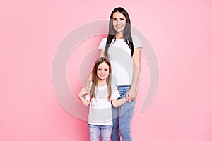 Photo of attractive young mom mother little daughter two ladies good mood stand close best friends hold arms wear casual