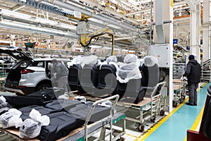 Photo of automobile production line. Modern auto assembly plant. Car black seats