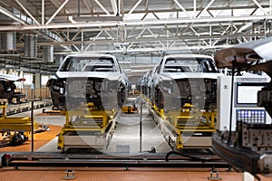 Photo of automobile production line. Modern car assembly plant. Auto industry. Interior of a high-tech factory, modern