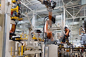 Photo of automobile production line. Modern car assembly plant. Auto industry. Interior of a high-tech factory, modern