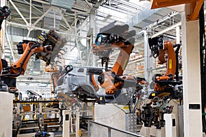 Photo of automobile production line. Modern car assembly plant. Auto industry. Interior of a high-tech factory, modern