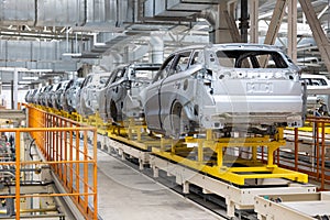 Photo of automobile production line. Welding car body. Modern car assembly plant. Auto industry. High-tech factory