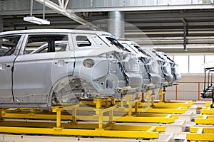 Photo of automobile production line. Welding car body. Modern car assembly plant. Auto industry. High-tech factory