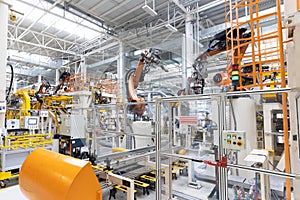 Photo of automobile production line. Welding car body. Modern car assembly plant. Auto industry. Interior of a high-tech