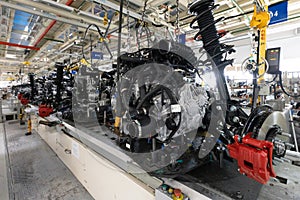 Photo of automobile production line. Welding car body. Modern car assembly plant. Auto industry. Interior of a high-tech