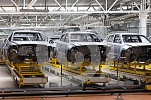 Photo of automobile production line. Welding car body. Modern car assembly plant. Auto industry. Interior of a high-tech