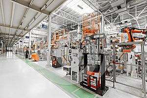 Photo of automobile production line. Welding car body. Modern car assembly plant. Auto industry. Interior of a high-tech