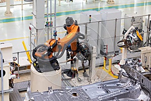 Photo of automobile production line. Welding car body. Modern car assembly plant. Auto industry. Interior of a high-tech