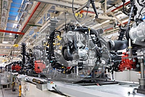 Photo of automobile production line. Welding car body. Modern car assembly plant. Auto industry. Interior of a high-tech