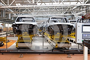 Photo of automobile production line. Welding car body. Modern car assembly plant. Auto industry. Interior of a high-tech