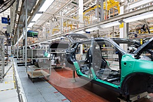 Photo of automobile production line. Welding car body. Modern car assembly plant. Auto industry. Interior of a high-tech