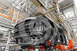 Photo of automobile production line. Welding car body. Modern car assembly plant. Auto industry. Interior of a high-tech