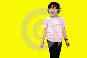 Photo background of Asian girl standing listening to music showing fun faces on the field.