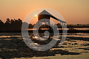 Photo Backlight Silhouette Southeast Asian wetland huts