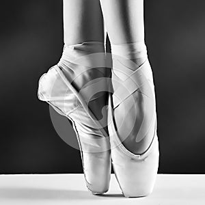 Photo of ballerina's pointes on black background