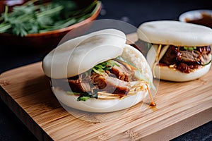 photo of bao bun, cut in half and stuffed with juicy barbecue pork