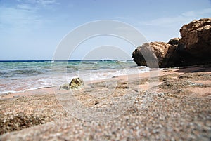 Photo of beautiful clear turquoise sea ocean water surface with ripples low waves on seascape sand beach background