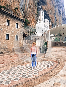 Beautiful Girl stands at the entrance to the old Orthodox Monastery