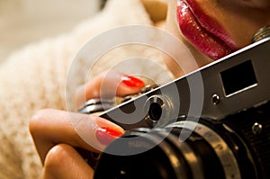 Photo of beautiful girl who& x27;s holding a vintage camera